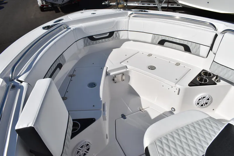 Slide: The Image of 2025 Blackfin 222CC boat interior with white seating and storage compartments. - 14