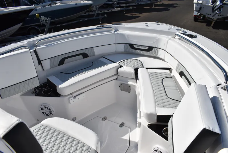 Slide: The Image of 2025 Blackfin 222CC boat interior with white cushioned seating and modern design. - 15