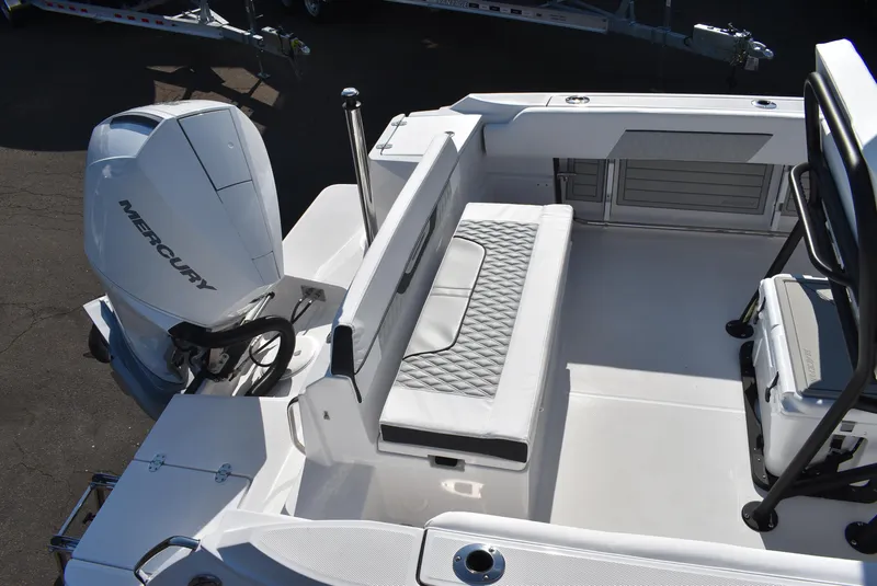 Slide: The Image of 2025 Blackfin 222CC boat interior with Mercury engine, featuring cushioned seating and storage. - 7