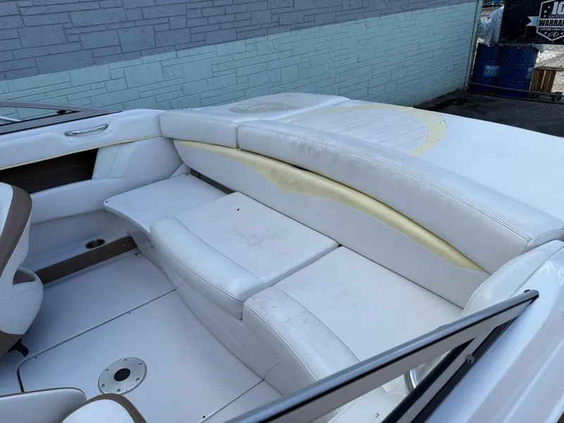 Slide: The Image of 2009 Four Winns H200 boat interior with white seating and light wear. - 5