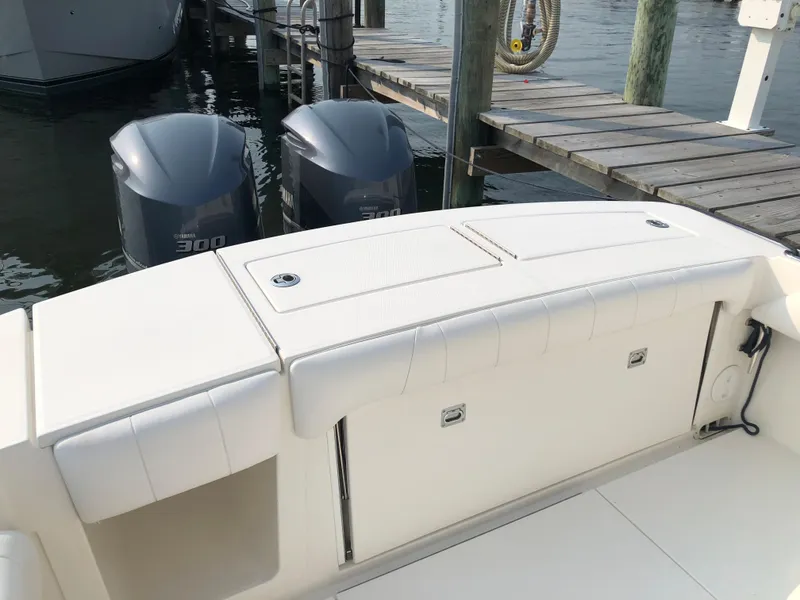 Slide: The Image of 2018 Regulator 28 Center Console boat with twin engines at dock. - 17