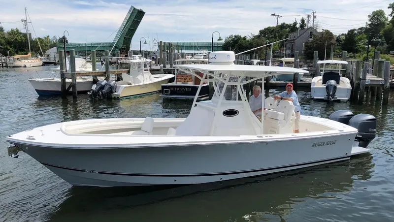 Slide: The Image of 2018 Regulator 28 Center Console boat with Optimus 360 Joystick Control in a marina. - 19