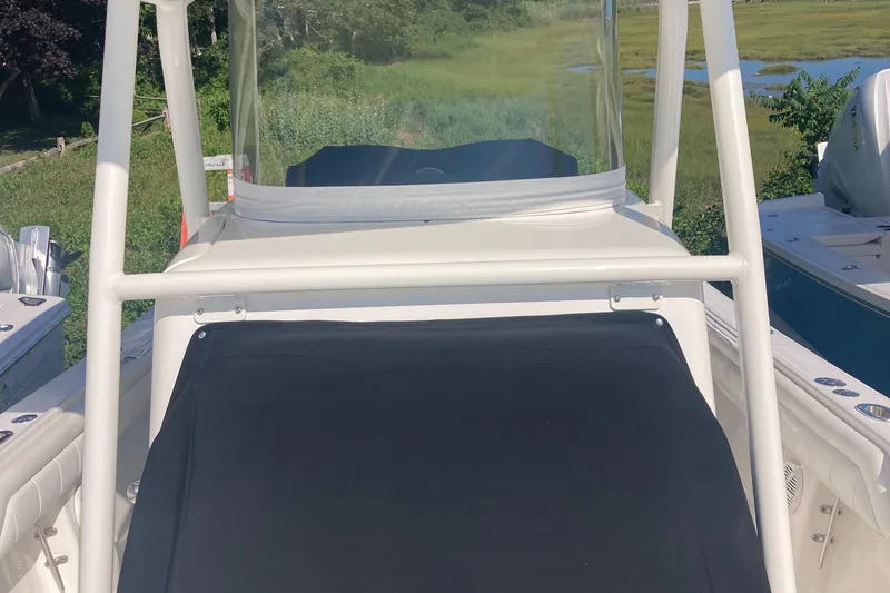 Slide: The Image of 2018 Regulator 28 Center Console boat with Optimus 360 Joystick Control, docked near greenery. - 23