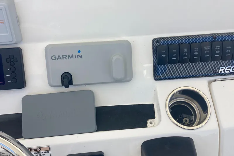 Slide: The Image of Control panel of 2018 Regulator 28 Center Console with Garmin and Yamaha covers. - 24