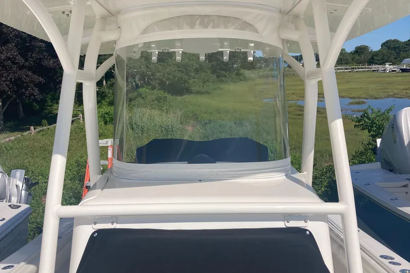 Slide: The Image of 2018 Regulator 28 Center Console boat with Optimus 360 Joystick Control, docked near grassy shoreline. - 25