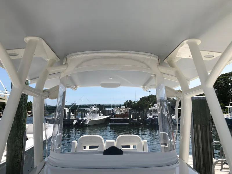 Slide: The Image of 2018 Regulator 28 Center Console boat with Optimus 360 Joystick Control at a marina. - 5