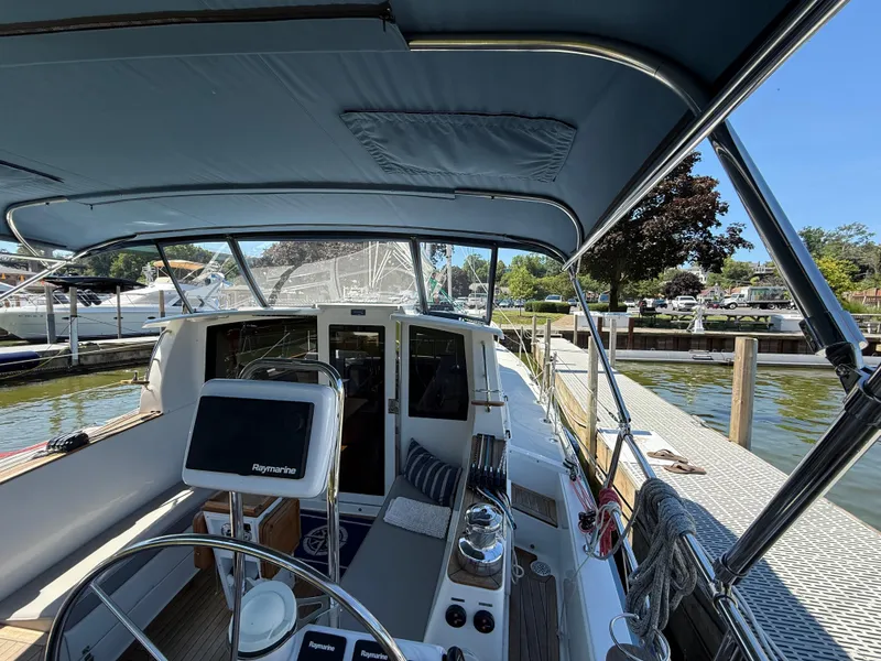 Slide: The Image of 2024 Tartan 455 yacht docked, featuring a spacious cockpit and modern navigation equipment. - 12