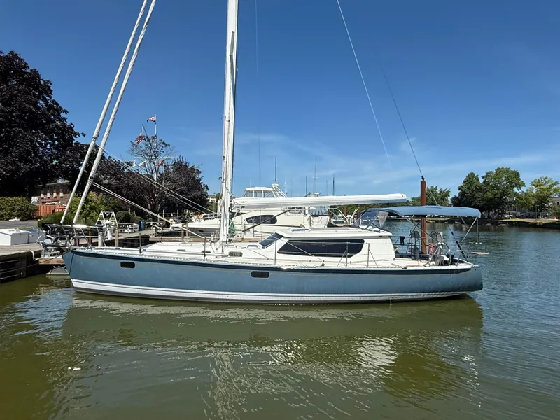 Slide: The Image of 2024 Tartan 455 sailboat docked in a marina under clear blue skies. - 13
