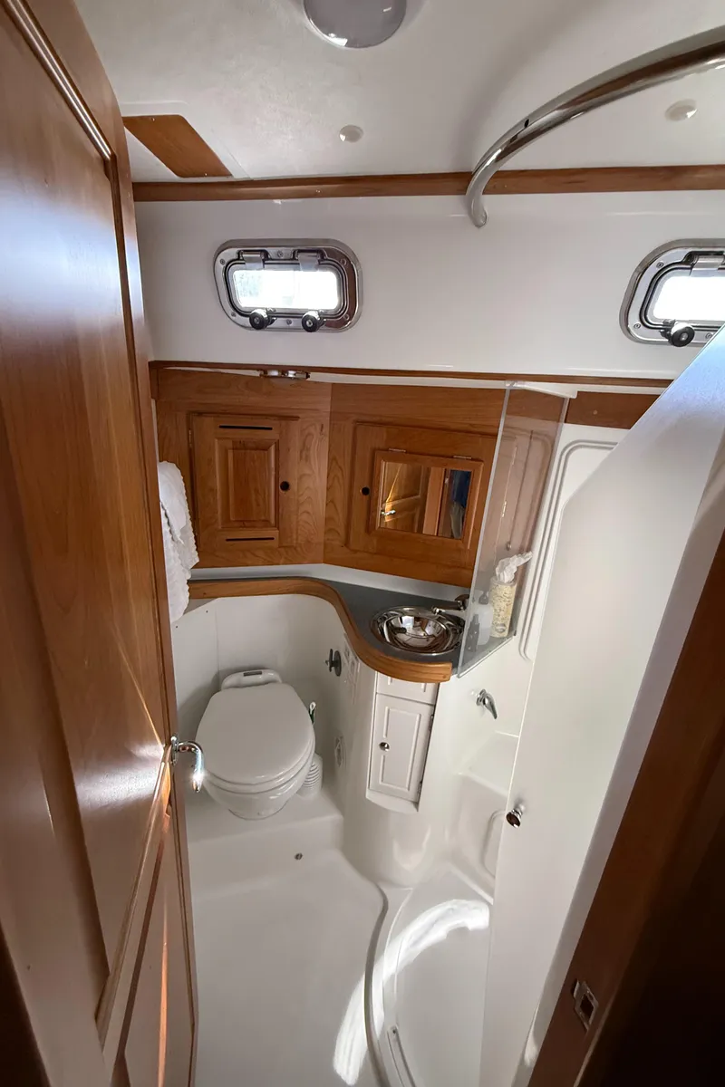 Slide: The Image of Luxurious 2024 Tartan 455 yacht bathroom with wooden cabinetry and modern fixtures. - 15