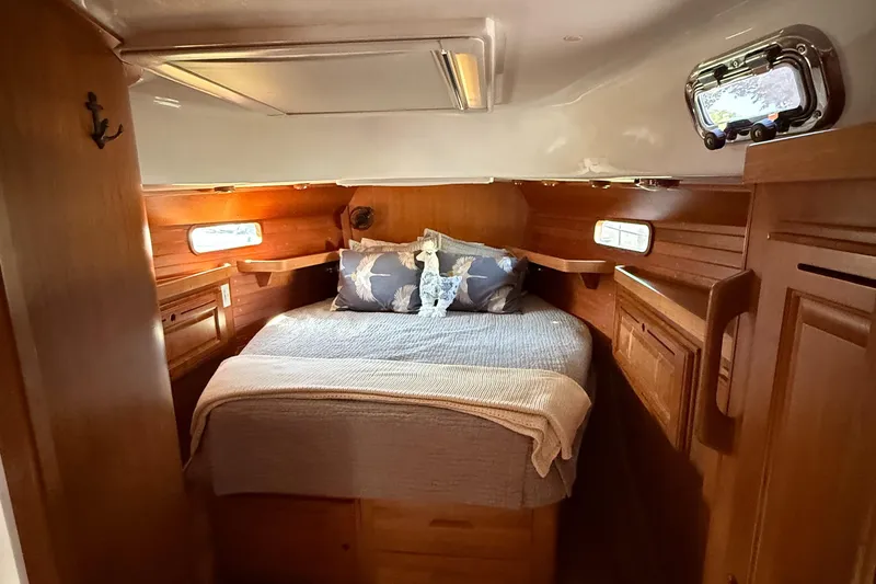 Slide: The Image of Cozy cabin interior of 2024 Tartan 455 yacht with wooden finish and comfortable bedding. - 16