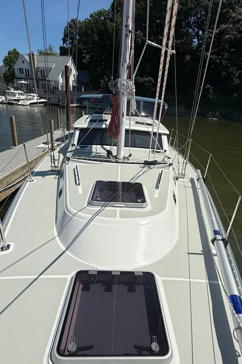 Slide: The Image of 2024 Tartan 455 sailboat docked, showcasing deck and cabin features. - 19