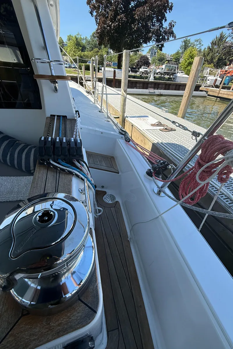 Slide: The Image of 2024 Tartan 455 sailboat deck with winch, ropes, and marina view. - 21