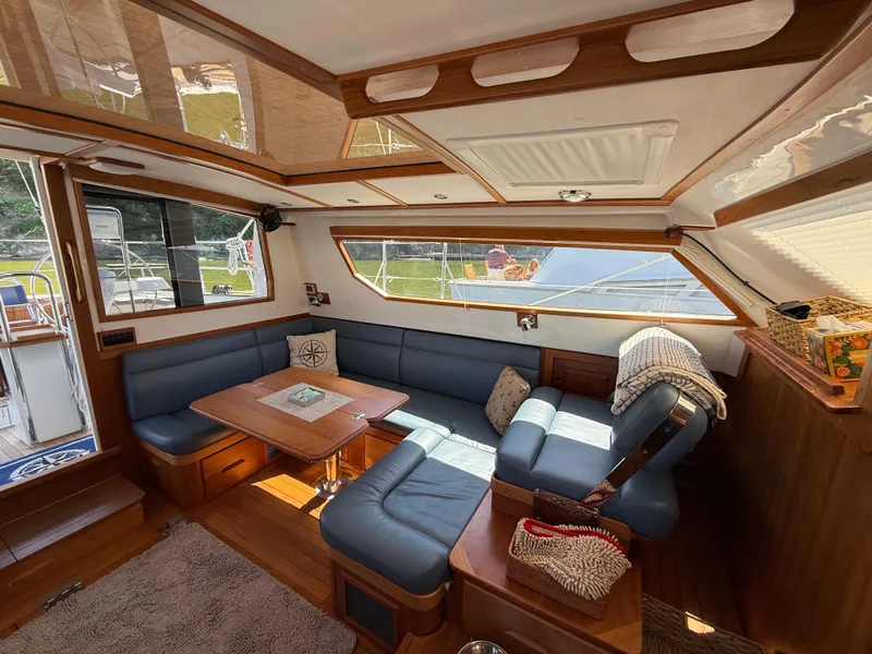 Slide: The Image of Luxurious interior of 2024 Tartan 455 yacht with blue seating and wooden accents. - 7