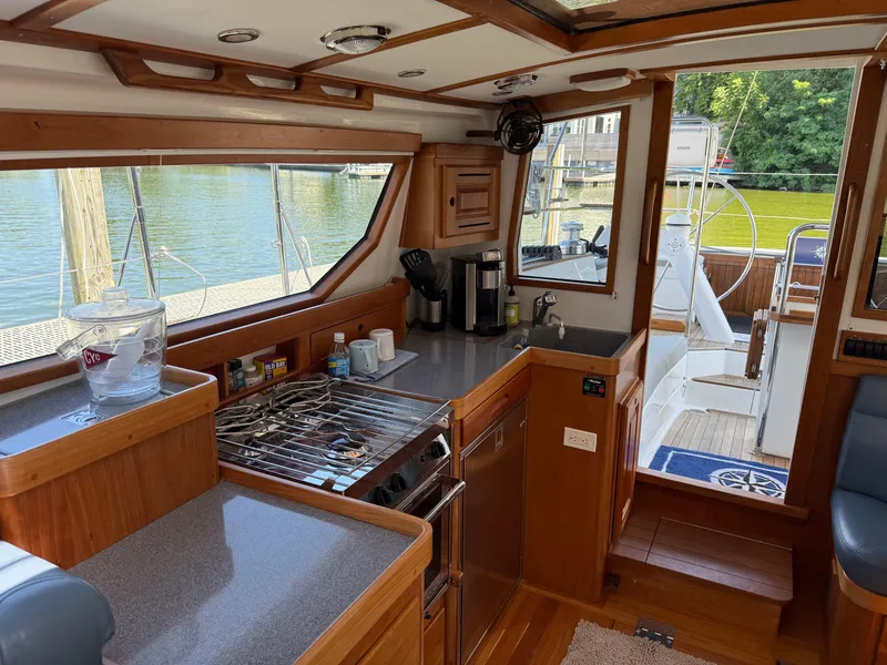 Slide: The Image of 2024 Tartan 455 yacht interior with modern kitchen and outdoor deck view. - 8