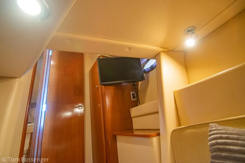 Slide: The Image of Interior of 2005 Meridian 341 Sedan yacht with cozy lighting and wooden finishes. - 30