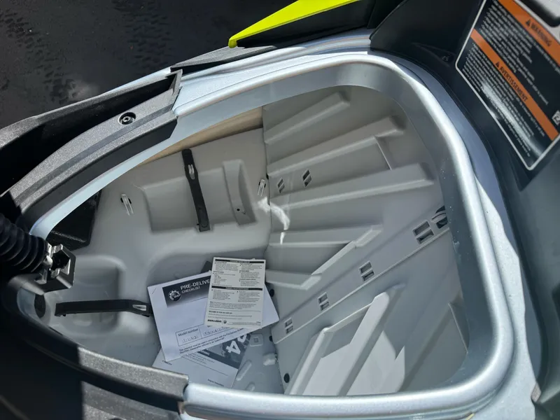 Slide: The Image of 2024 Sea-Doo RXP-X 325 storage compartment with documents inside. - 4
