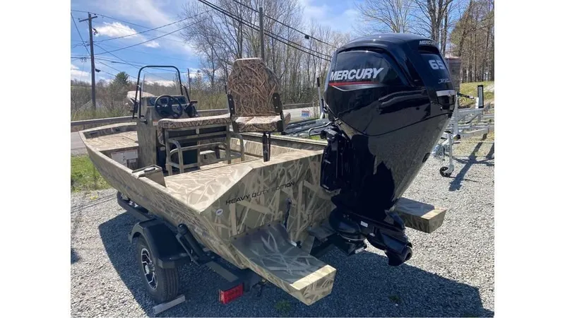 Slide: The Image of 2025 Lowe Roughneck RX1760 Pathfinder boat with Mercury 65 HP engine, parked outdoors. - 4