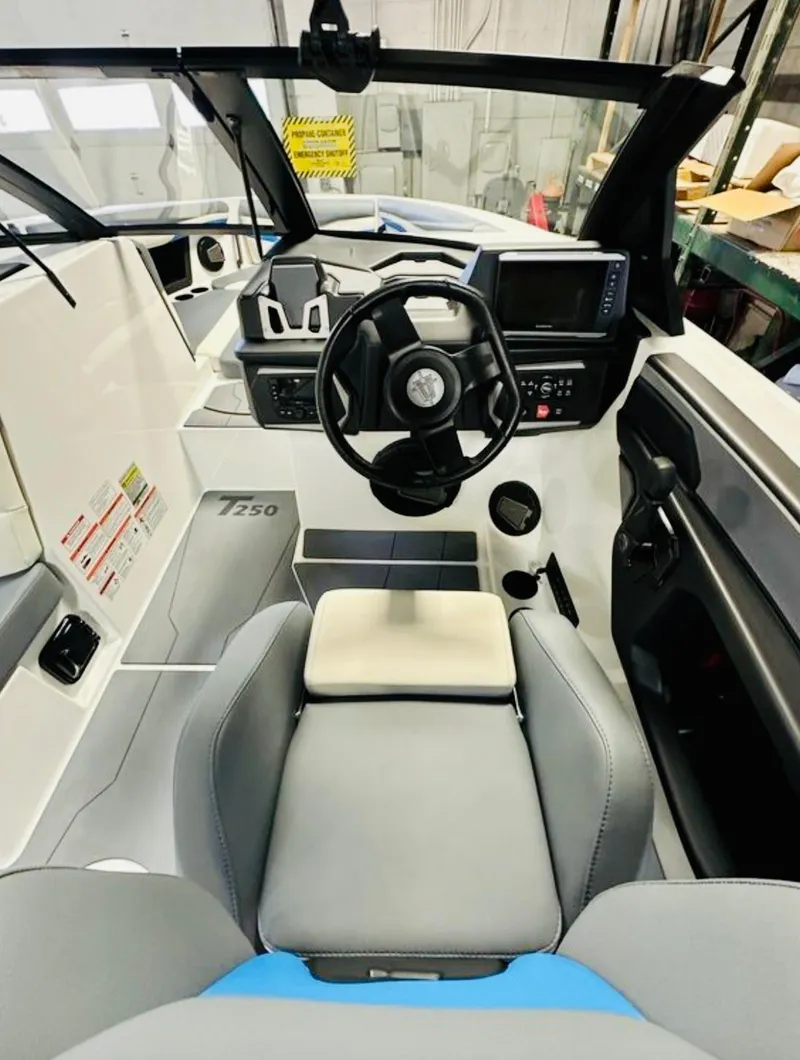 Slide: The Image of 2024 Axis T250 boat interior with gray and white seating, modern design, and logo on the floor. - 11