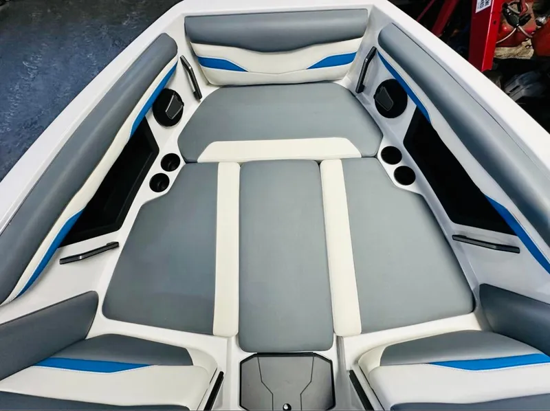 Slide: The Image of 2024 Axis T250 boat cockpit with steering wheel, dashboard, and seating. - 12