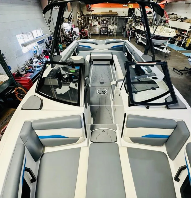 Slide: The Image of 2024 Axis T250 boat interior with gray and blue cushioned seating. - 13