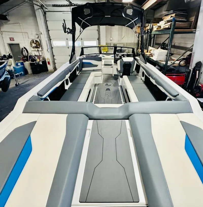 Slide: The Image of 2024 Axis T250 boat rear view in a workshop, showcasing propeller and wake system. - 7