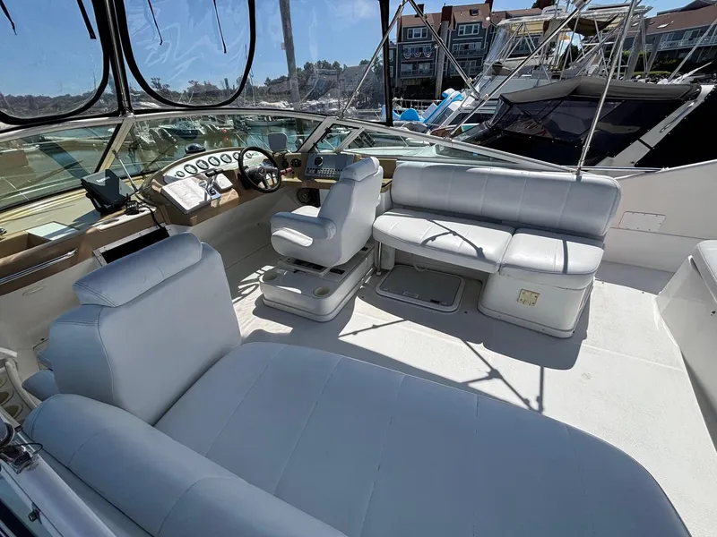 Slide: The Image of 2001 Carver 350 Mariner boat interior with white seating and control panel. - 10