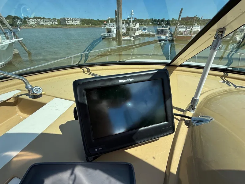 Slide: The Image of Carver 350 Mariner 2001 helm with Raymarine display, docked at marina. - 11
