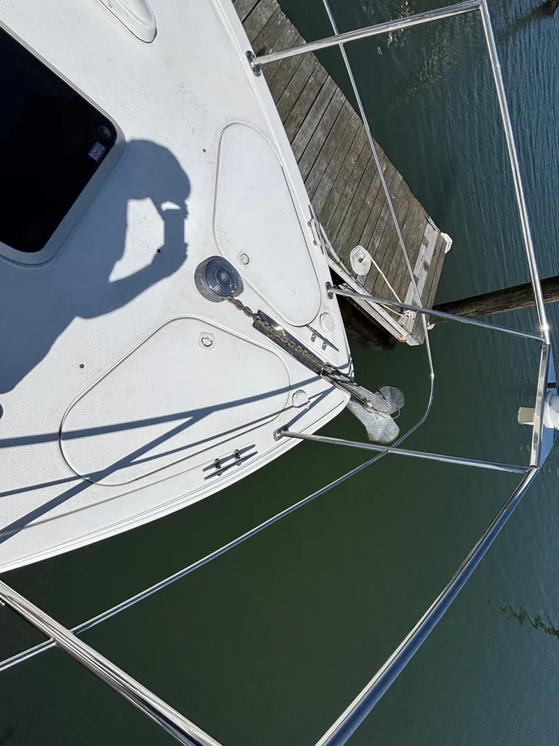 Slide: The Image of 2001 Carver 350 Mariner boat docked, showing deck and railing with shadow. - 14