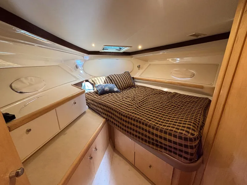 Slide: The Image of 2001 Carver 350 Mariner cabin with bed, storage, and window. - 15