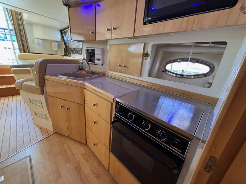 Slide: The Image of Interior of 2001 Carver 350 Mariner yacht kitchen with wood cabinets and appliances. - 16
