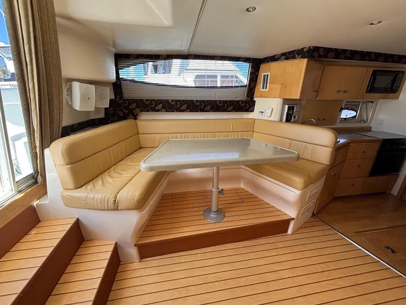 Slide: The Image of Interior of 2001 Carver 350 Mariner yacht with beige seating and wooden flooring. - 19