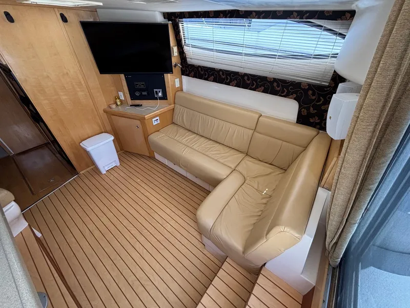 Slide: The Image of Interior of 2001 Carver 350 Mariner yacht with beige leather seating and wood flooring. - 20