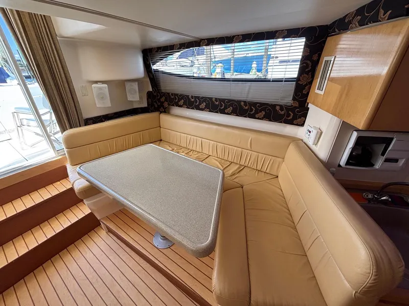 Slide: The Image of Interior of 2001 Carver 350 Mariner yacht with beige seating and wooden flooring. - 21