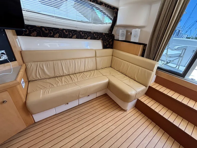 Slide: The Image of Luxurious interior of 2001 Carver 350 Mariner yacht with beige leather seating and wooden flooring. - 22