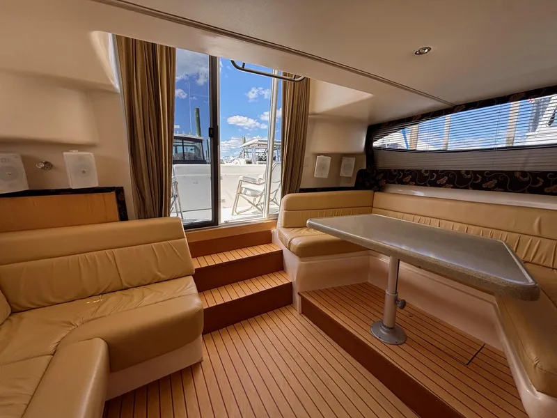 Slide: The Image of Interior of 2001 Carver 350 Mariner yacht with beige seating and table. - 23