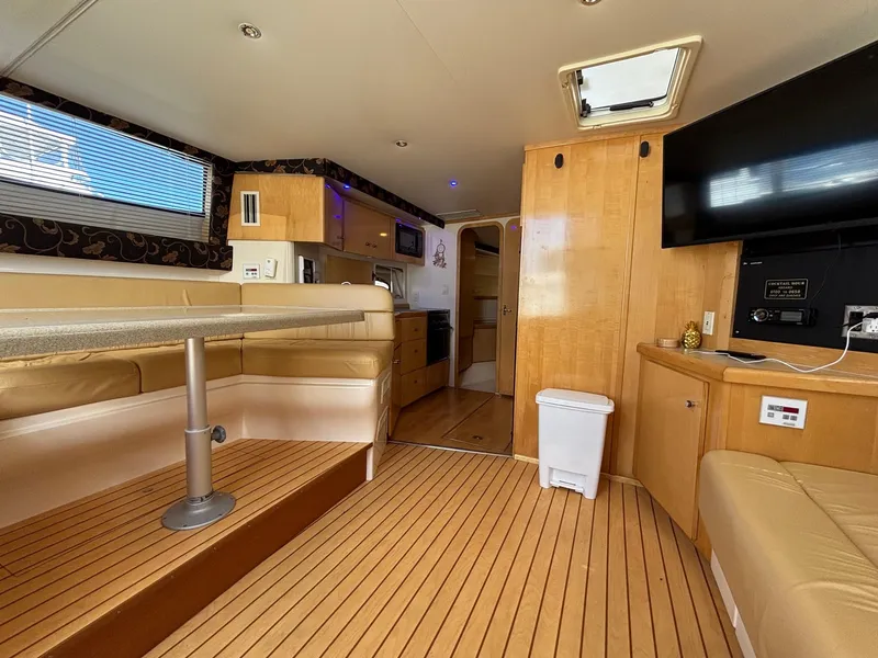 Slide: The Image of Interior of 2001 Carver 350 Mariner yacht with wood flooring and modern amenities. - 24