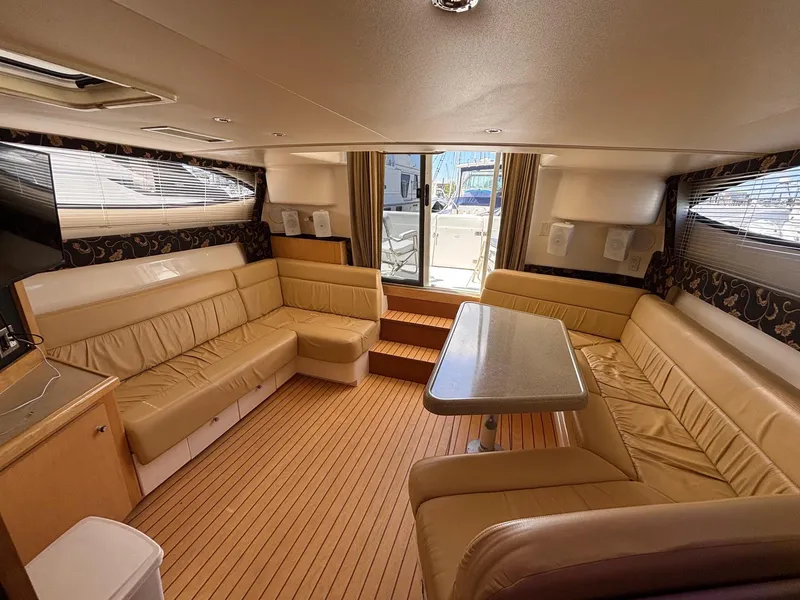 Slide: The Image of Luxurious interior of 2001 Carver 350 Mariner yacht with beige seating and wooden flooring. - 25