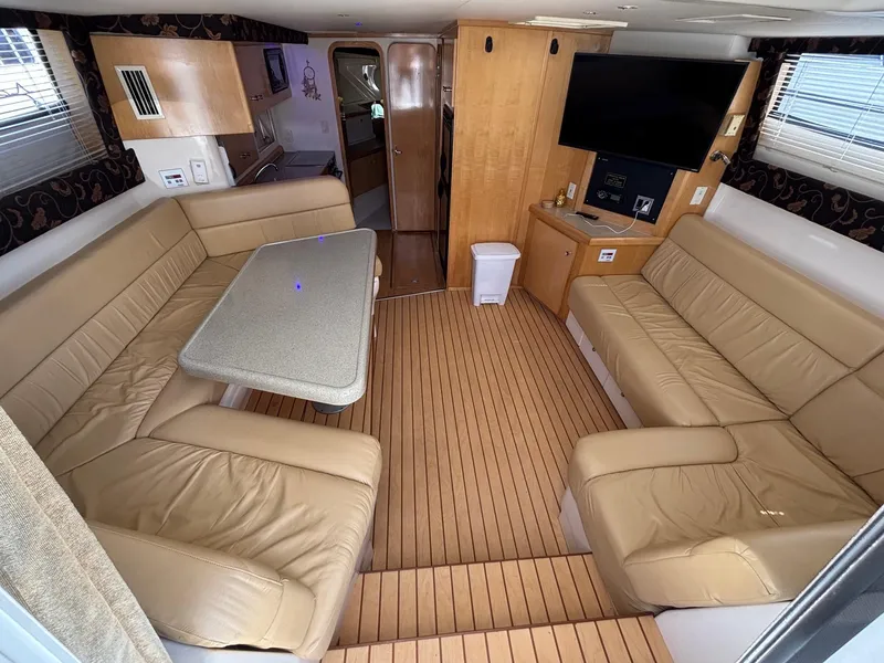 Slide: The Image of Interior of 2001 Carver 350 Mariner yacht with beige seating and wooden flooring. - 26