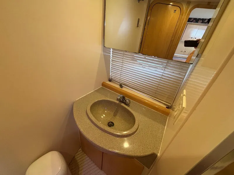 Slide: The Image of Compact bathroom in 2001 Carver 350 Mariner yacht with sink, mirror, and blinds. - 28
