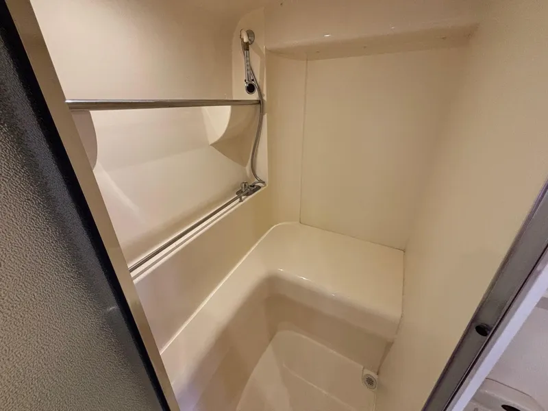 Slide: The Image of 2001 Carver 350 Mariner shower area with built-in seat and chrome fixtures. - 31