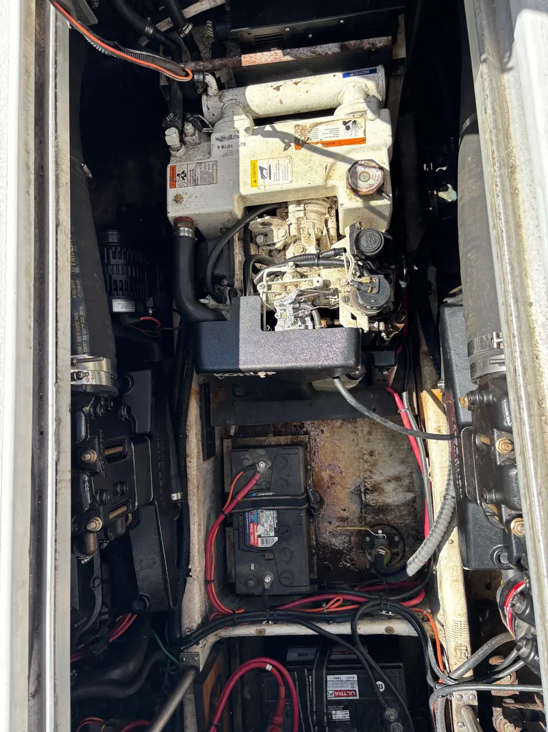 Slide: The Image of Engine compartment of a 2001 Carver 350 Mariner with visible wiring and components. - 34
