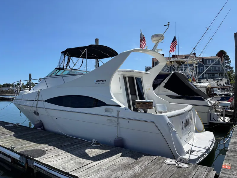 Slide: The Image of 2001 Carver 350 Mariner yacht docked at marina under clear blue sky. - 4