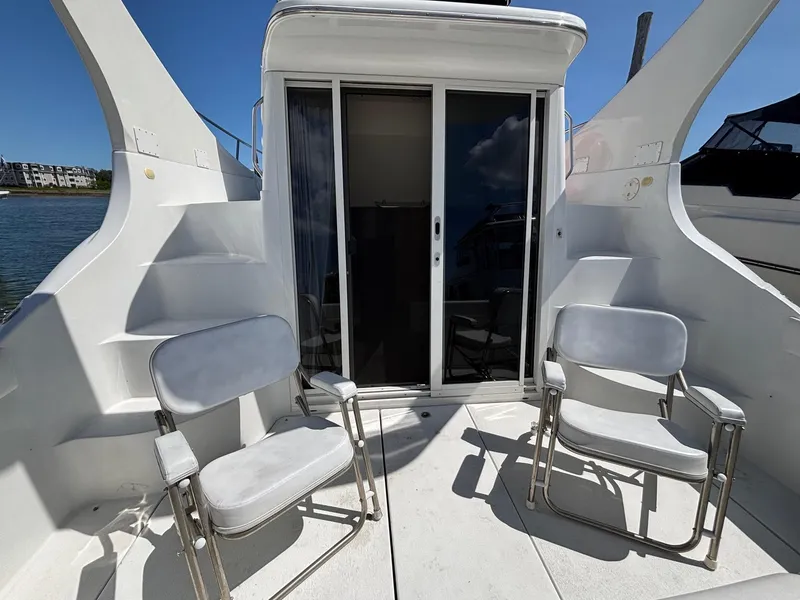 Slide: The Image of 2001 Carver 350 Mariner yacht deck with two chairs and sliding glass door. - 5