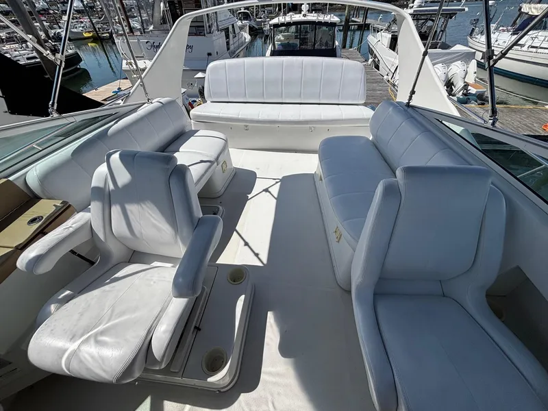 Slide: The Image of 2001 Carver 350 Mariner yacht interior with white seating, docked at marina. - 7