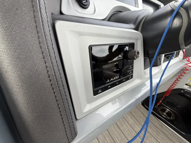 Slide: The Image of 2021 Manitou 25 XT SRS dashboard featuring JL Audio system and steering wheel. - 18