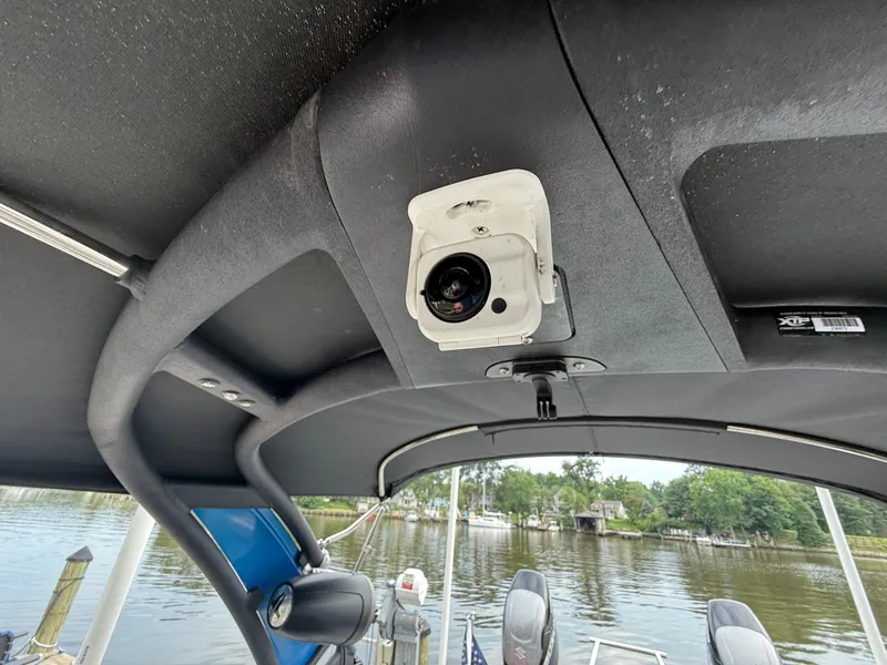 Slide: The Image of 2021 Manitou 25 XT SRS boat interior with mounted camera on the ceiling. - 19