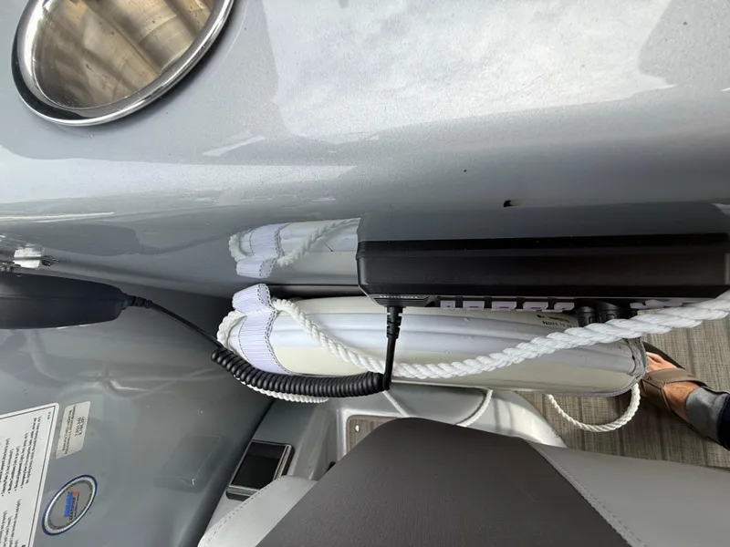 Slide: The Image of 2021 Manitou 25 XT SRS boat interior with rope and control panel. - 22