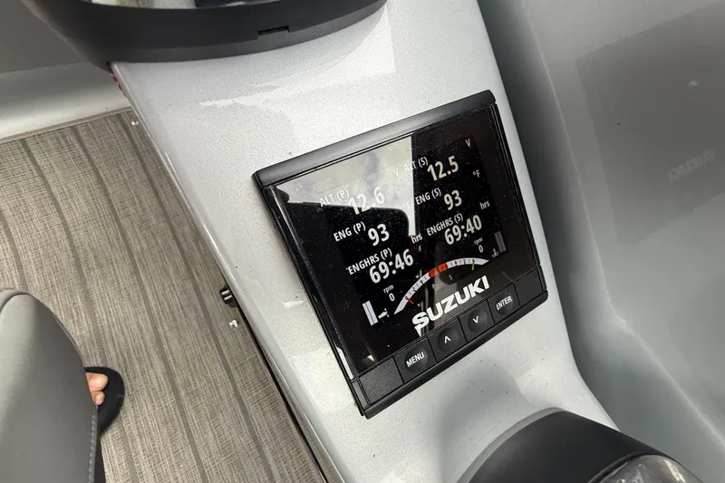 Slide: The Image of Suzuki display on 2021 Manitou 25 XT SRS boat dashboard, showing engine metrics. - 23