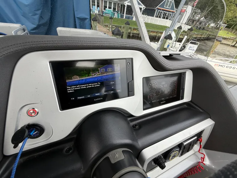 Slide: The Image of Dashboard of a 2021 Manitou 25 XT SRS boat with Garmin displays. - 5