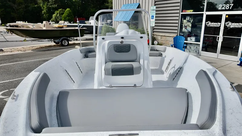 Slide: The Image of 2026 ALK2 Powerboats 18 CRS with gray seating, displayed outside a showroom. - 10